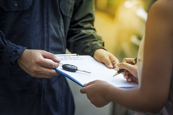 signing car rental agreement